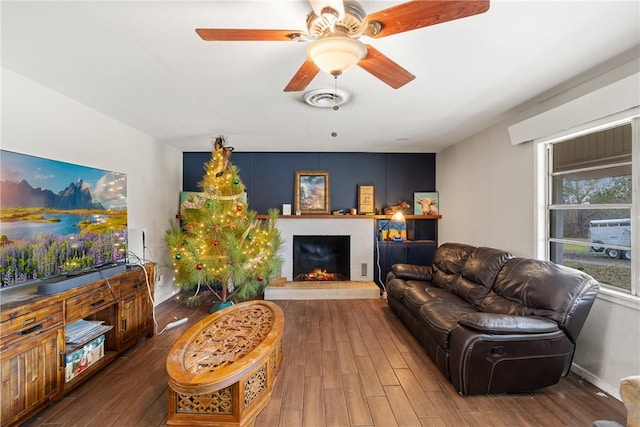 living room featuring ceiling fan and dark wood-type flooring