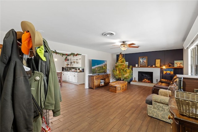 living room featuring hardwood / wood-style floors and ceiling fan