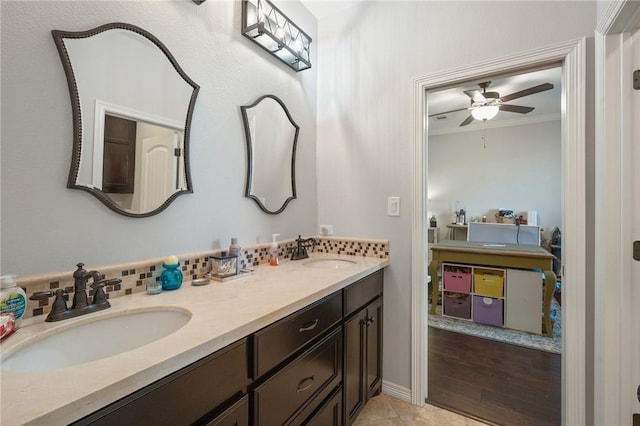 bathroom featuring vanity, ornamental molding, and ceiling fan