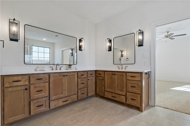 bathroom featuring tile patterned flooring, vanity, and ceiling fan