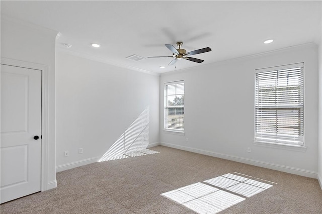 spare room featuring light carpet, plenty of natural light, and ceiling fan