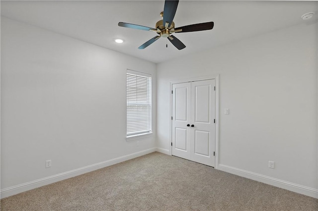 empty room with light carpet and ceiling fan