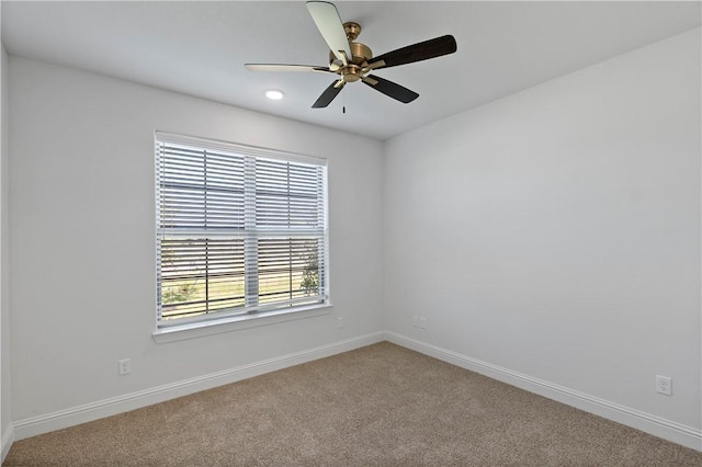 carpeted empty room with plenty of natural light and ceiling fan