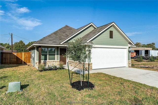 view of front facade with a garage and a front yard