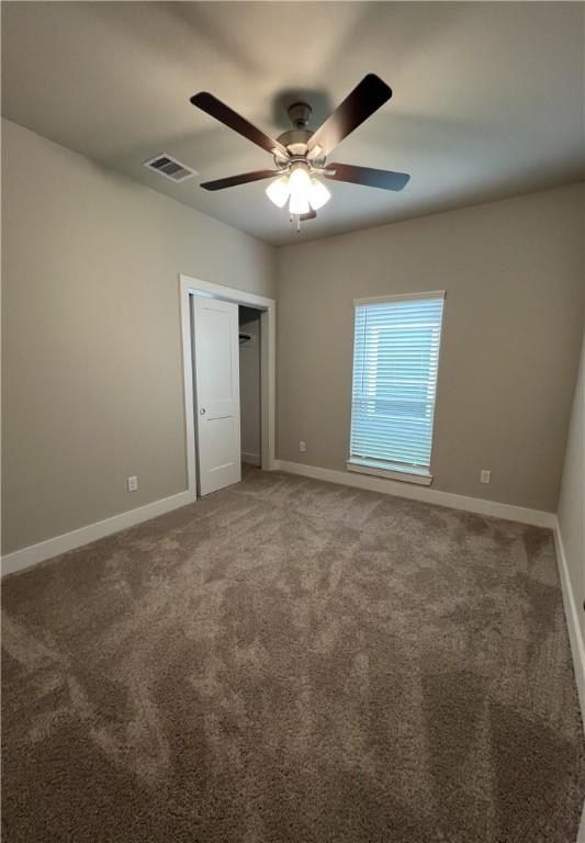 5307 Lyle Pl, Bryan, TX 77807 - unfurnished bedroom featuring carpet floors and a ceiling fan