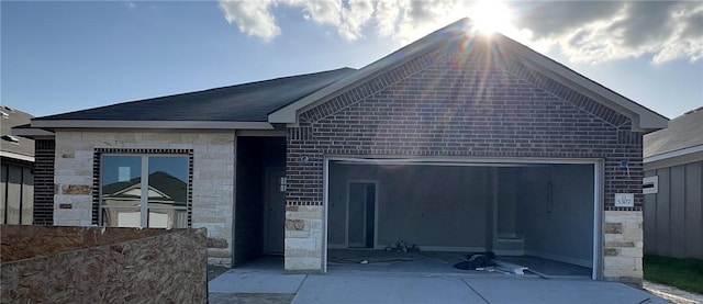 5307 Lyle Pl, Bryan, TX 77807 - ranch-style home with stone siding and an attached garage