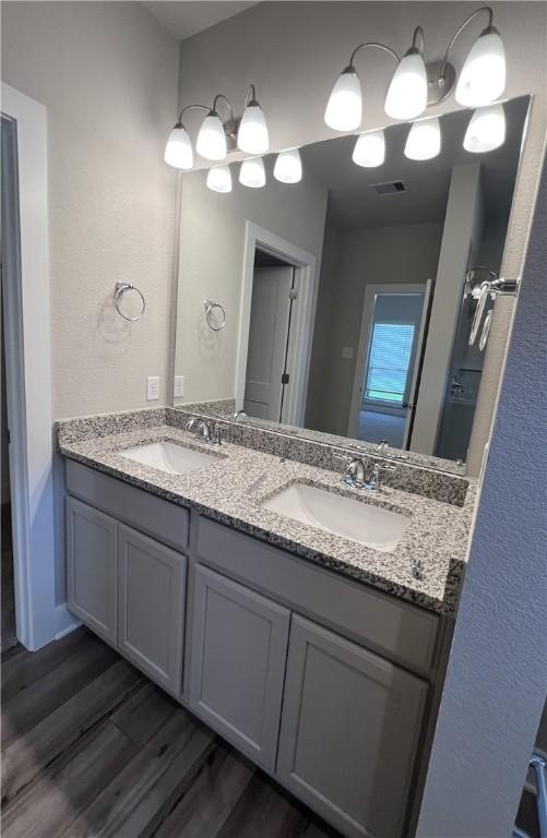 5307 Lyle Pl, Bryan, TX 77807 - full bathroom with double vanity and wood finished floors
