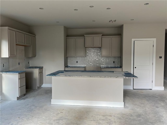 5307 Lyle Pl, Bryan, TX 77807 - kitchen featuring a center island, unfinished concrete flooring, gray cabinets, decorative backsplash, and recessed lighting