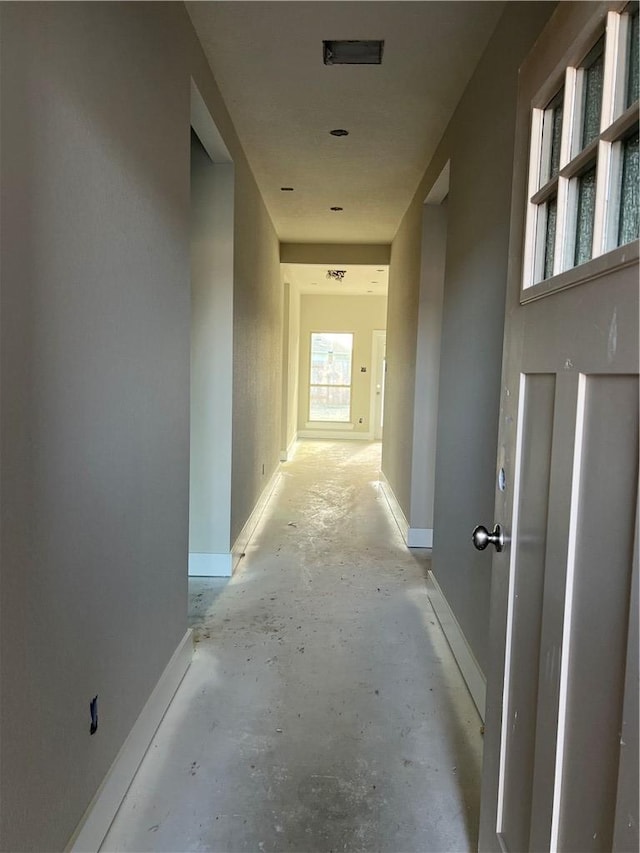 5307 Lyle Pl, Bryan, TX 77807 - corridor with unfinished concrete flooring and baseboards