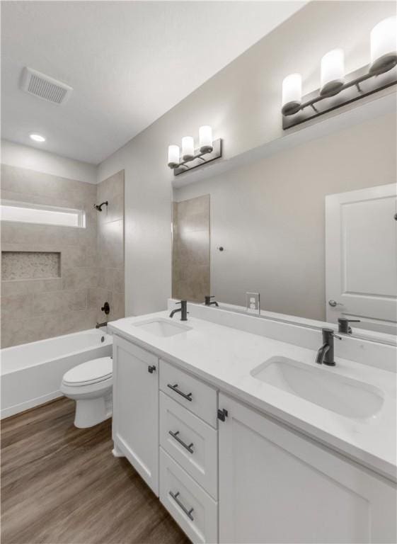 2816 Bombay Dr, Bryan, TX 77808 - full bathroom featuring hardwood / wood-style floors, vanity, tiled shower / bath combo, and toilet
