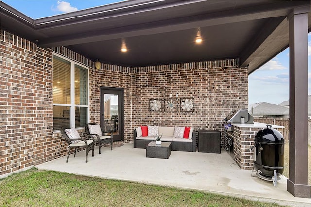 view of patio / terrace with an outdoor kitchen, an outdoor hangout area, and area for grilling