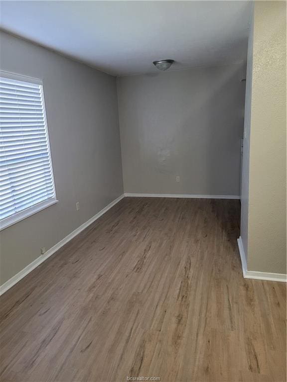 unfurnished room featuring hardwood / wood-style floors