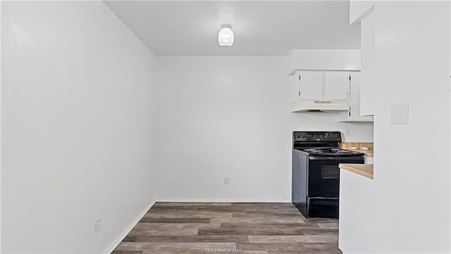 kitchen with dark hardwood / wood-style flooring, black range with electric cooktop, and white cabinets