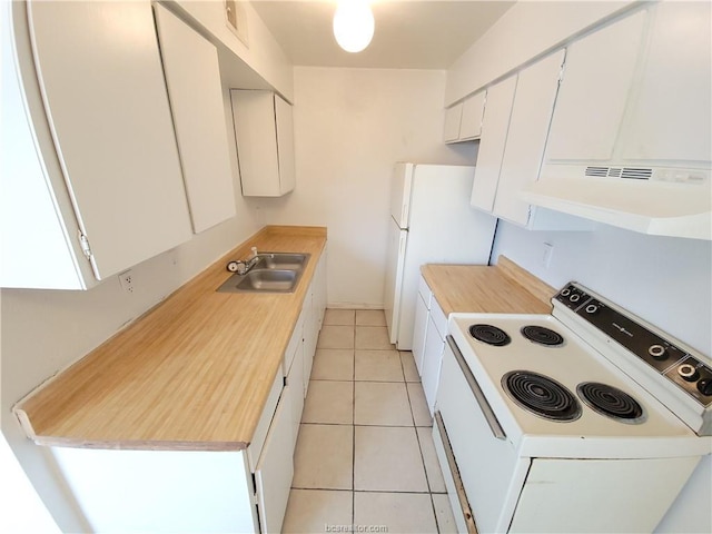 kitchen with sink, white appliances, light tile patterned floors, and white cabinets