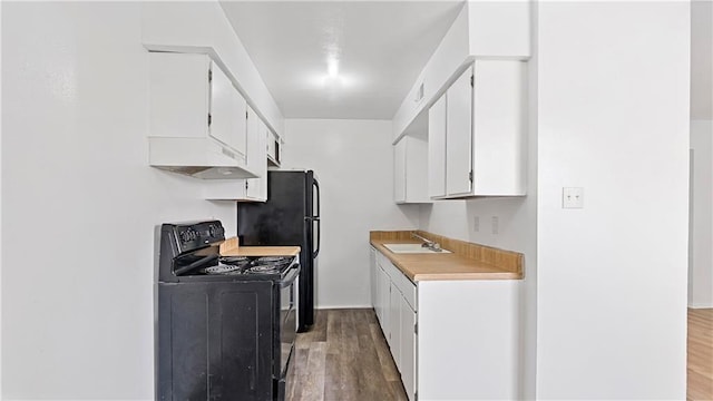 kitchen featuring white cabinetry, sink, hardwood / wood-style floors, and electric range