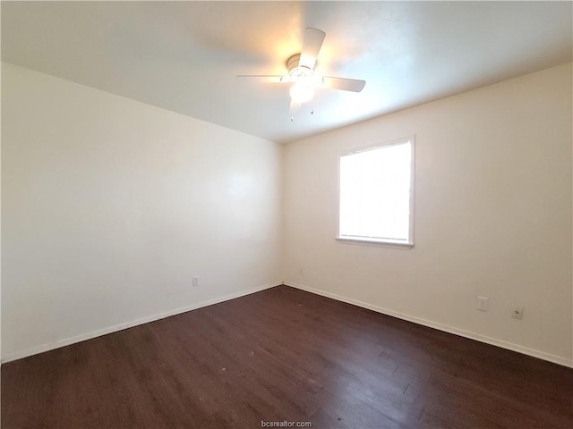 empty room featuring dark hardwood / wood-style floors and ceiling fan