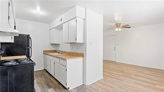 kitchen with black appliances, sink, white cabinets, ceiling fan, and light hardwood / wood-style floors