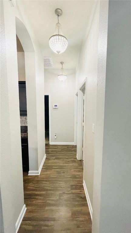 15481 Baker Meadow Loop, College Station, TX 77845 - corridor featuring dark wood finished floors, arched walkways, and baseboards