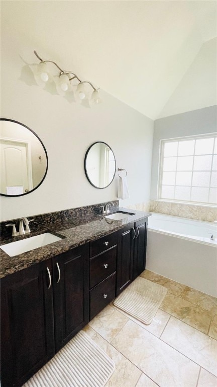 15481 Baker Meadow Loop, College Station, TX 77845 - bathroom with double vanity, a garden tub, and vaulted ceiling