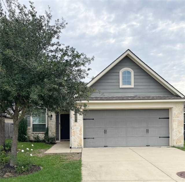 15481 Baker Meadow Loop, College Station, TX 77845 - view of front facade with concrete driveway, a garage, stone siding, and a front yard