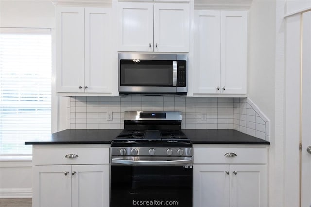 kitchen with white cabinets, appliances with stainless steel finishes, and tasteful backsplash