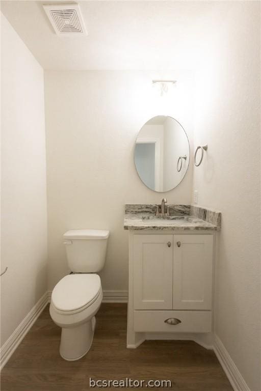 bathroom featuring hardwood / wood-style floors, vanity, and toilet