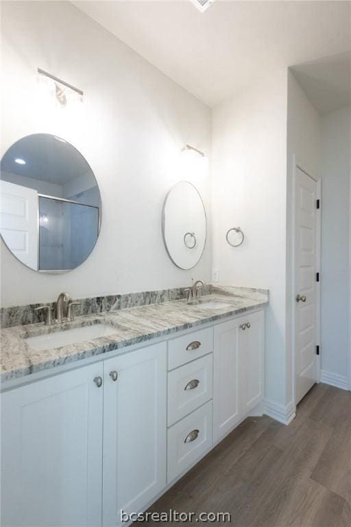 bathroom with hardwood / wood-style floors and vanity