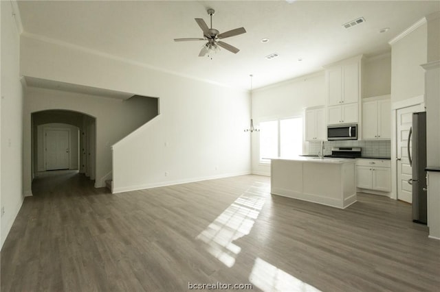 kitchen featuring white cabinetry, an island with sink, dark wood-type flooring, and appliances with stainless steel finishes