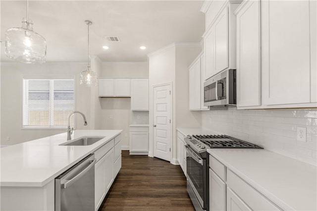 kitchen with white cabinetry, sink, an island with sink, and stainless steel appliances