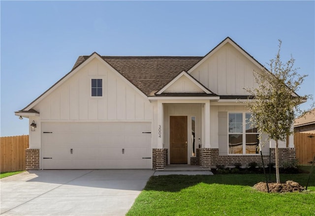 view of front of house featuring a front lawn and a garage