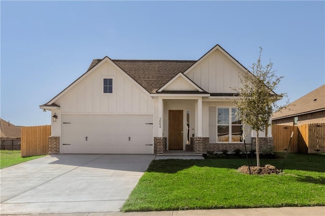 view of front of property with a front yard and a garage