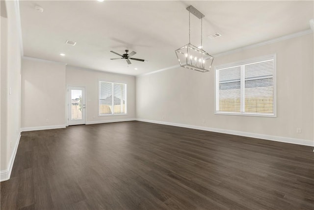 empty room featuring ornamental molding, ceiling fan with notable chandelier, and dark wood-type flooring