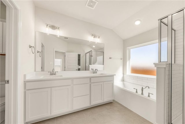 full bathroom featuring tile patterned flooring, vanity, independent shower and bath, and vaulted ceiling