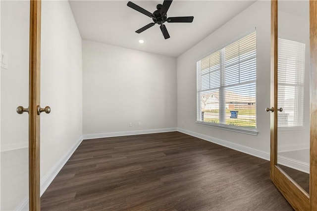 spare room featuring ceiling fan and dark hardwood / wood-style floors