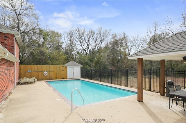 view of pool featuring a patio area and a storage unit