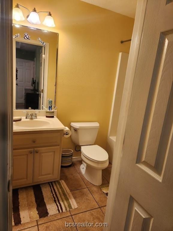 bathroom with walk in shower, tile patterned flooring, vanity, and toilet