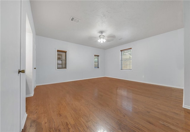 empty room featuring hardwood / wood-style floors and ceiling fan