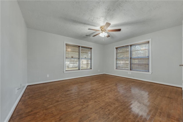 spare room with ceiling fan, dark hardwood / wood-style floors, and a textured ceiling