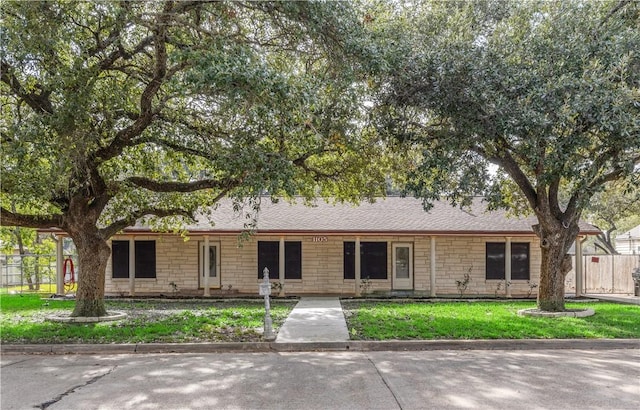 ranch-style home with a front lawn