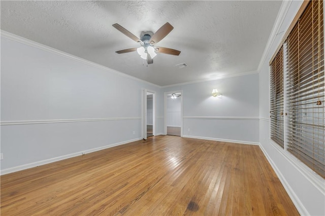 unfurnished room featuring hardwood / wood-style flooring, ceiling fan, crown molding, and a textured ceiling