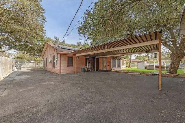 view of front of house featuring a carport and solar panels