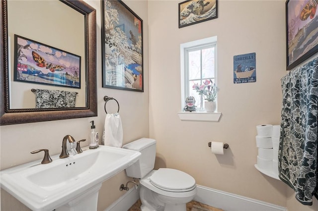 4314 Hadleigh Ln, College Station, TX 77845 - bathroom featuring a sink, toilet, and baseboards