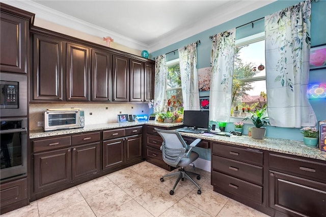 4314 Hadleigh Ln, College Station, TX 77845 - office area with built in study area, plenty of natural light, light tile patterned floors, and ornamental molding