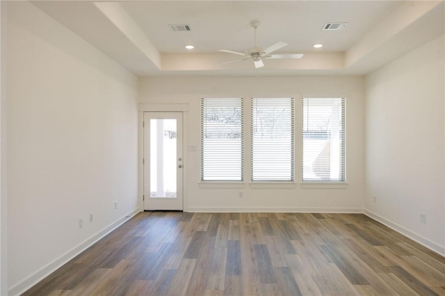 2784 Messenger Way, Bryan, TX 77803 - unfurnished room with a raised ceiling, ceiling fan, wood finished floors, and baseboards