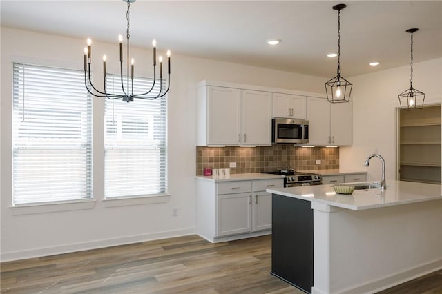 2784 Messenger Way, Bryan, TX 77803 - kitchen featuring appliances with stainless steel finishes, a sink, tasteful backsplash, light countertops, and light wood-style flooring
