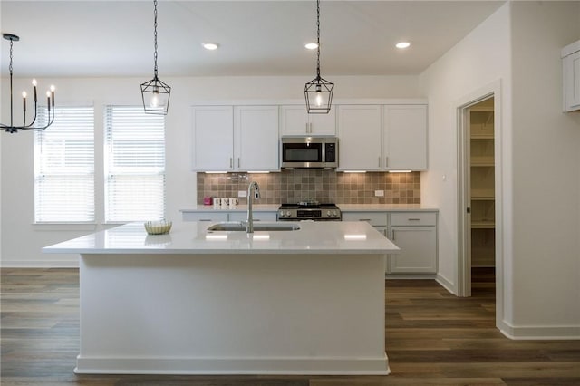 2784 Messenger Way, Bryan, TX 77803 - kitchen featuring stainless steel appliances, a sink, light countertops, decorative backsplash, and dark wood-style flooring