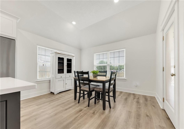 dining space with recessed lighting, baseboards, light wood-style flooring, and lofted ceiling