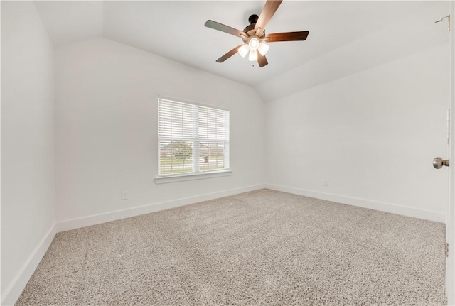 carpeted spare room with a ceiling fan, baseboards, and lofted ceiling