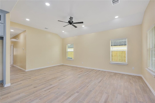 unfurnished room with ceiling fan, lofted ceiling, and light wood-type flooring