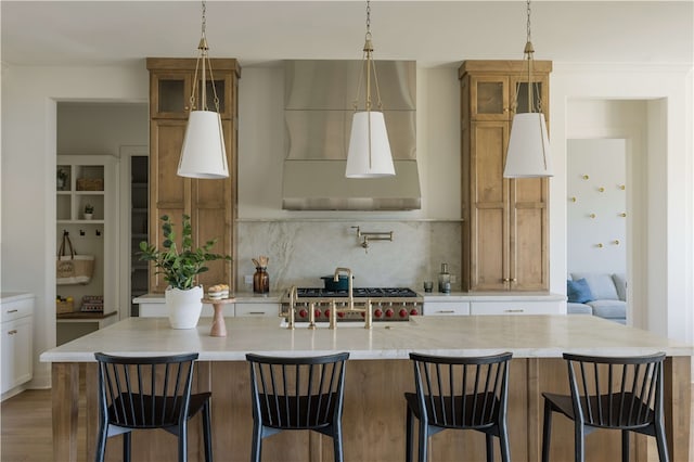 kitchen featuring pendant lighting, a large island, and light hardwood / wood-style floors